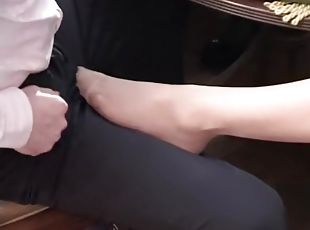 Footjob underneath the table