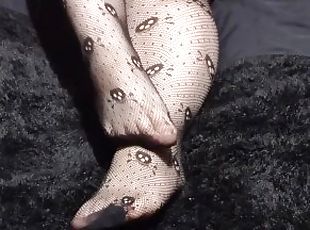 Close up of Wolf's cute feet in skull fishnets for your foot fetish pleasure