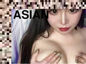 Asian girl plays with her big natural tits