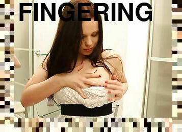 Stunning brunette fingers her pussy shaving in the bathroom