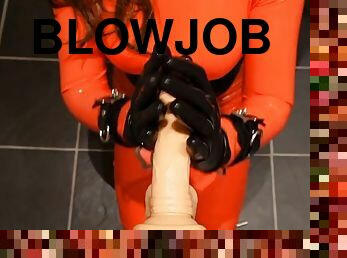Teaching blowjob to a red latex doll