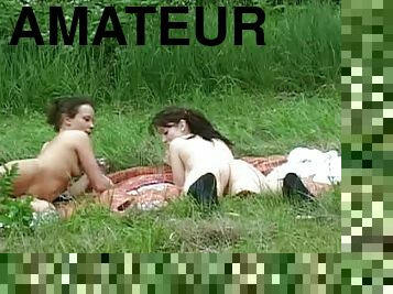 Amateur busty chicks are playing on the grass