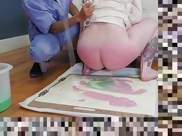 Submissive makes art with colored enema juices