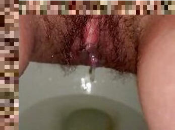 Hairy pussy drains piss after cumming
