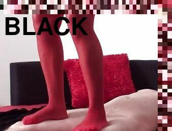 Black Lucy, the black Mistress, tramples on her white slave bobby in red stockings up and down.