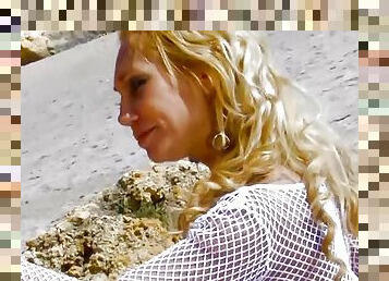 Busty German MILF with blonde hair loves riding a cock on the beach