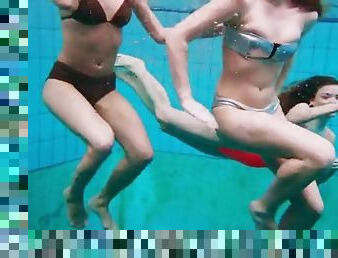 Three naked girls having fun in the water