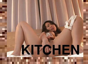 Horny brunette masturbates in the kitchen with a dildo