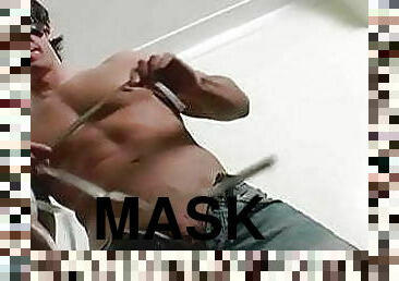 Hunky muscular stud with mask on his face masturbates