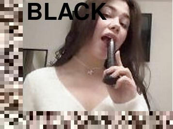 Sucking a black toy cock