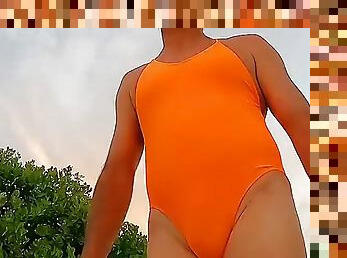 Orange one-piece swimsuit on the beach