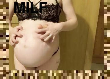 Massive pregnant slut playing with huge bump