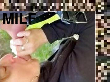 MILF gives outside blowjob, and takes cum in mouth
