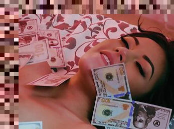 Kendra Spade lies in a pile of cash after a rousing pounding