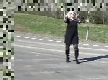 Business lady flashing on the road