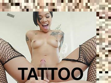 Tattooed hottie in fishnet stockings relishes hard pussy pounding