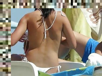 Girl sunbathing topless but voyeur takes off boobs