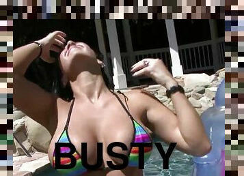 Busty brunette Jayden outdoors in the pool - wet striptease in stripe bikini