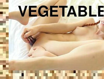 Redhead girl play with vegetables