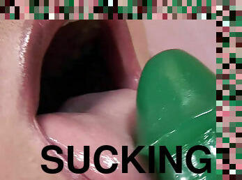Cindy is sucking and licking that nice green dildo