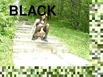 Gorgeous and charming Vika in black stockings is pissing outdoors
