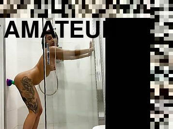 Tattooed teen gril fucking her sex toy in the shower