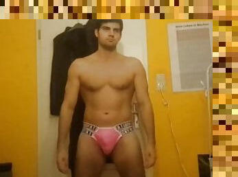 Skinny guy stripping in pink thong