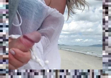 Public handjob on the beach - people around