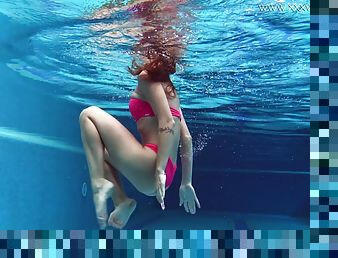 Skinny bikini girl gets naked and shows off her ass underwater