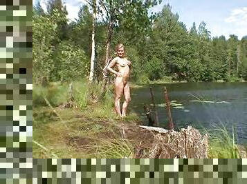 She sensually poses nude lakeside