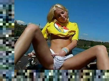 Tight blonde teen plays with her twat outdoors
