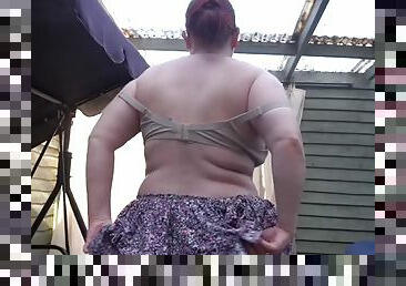 British woman in hot summer shade in miniskirt and bra