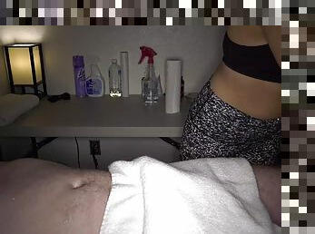 Clothed masseuse chick gives an unforgettable handjob on table