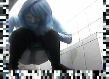 Blue haired babe is peeing in the toilet