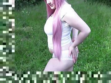 Thick babe with pink hair gets wet in open field