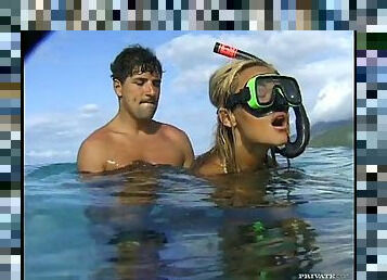 Slim blonde in a diving mask gives a blowjob in the sea