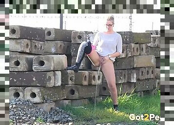 Sweater and tights on chick pissing outdoors